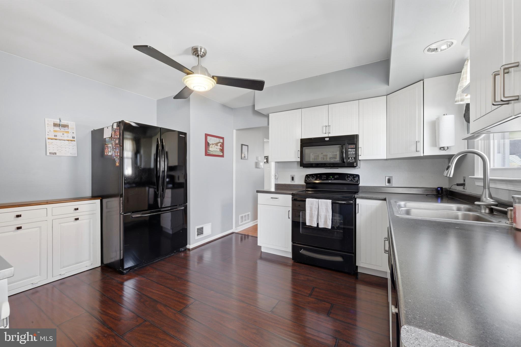 129 Maple Avenue Brookhaven, PA 19015 - Photo 6 of 16 a kitchen with granite countertop stainless steel appliances and wooden floor