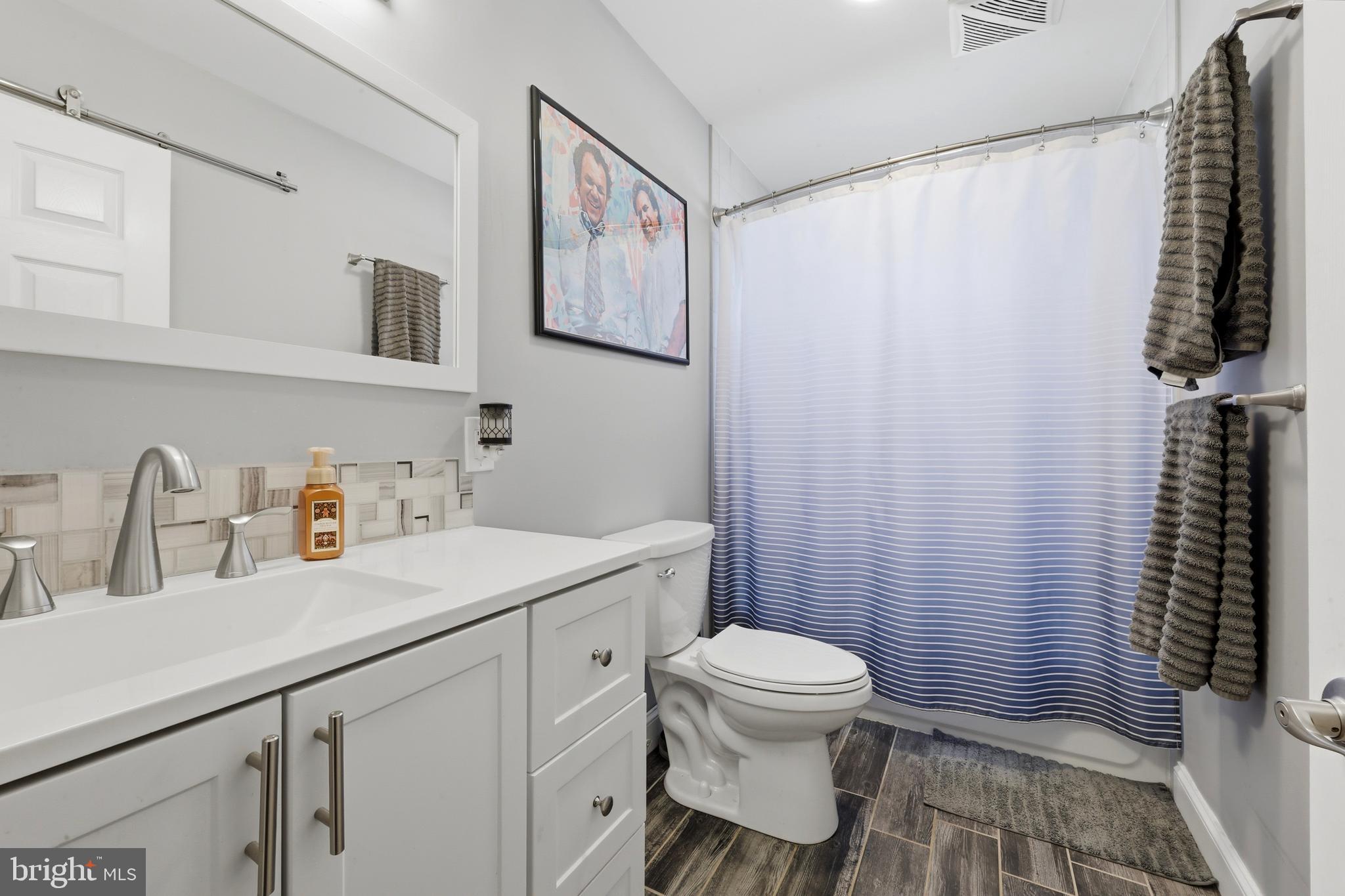 129 Maple Avenue Brookhaven, PA 19015 - Photo 8 of 16 a bathroom with a sink toilet and shower