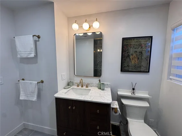 a close view of a refrigerator in kitchen and stainless steel appliances wooden floor