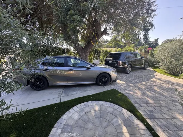 a view of a patio with chairs and a small yard