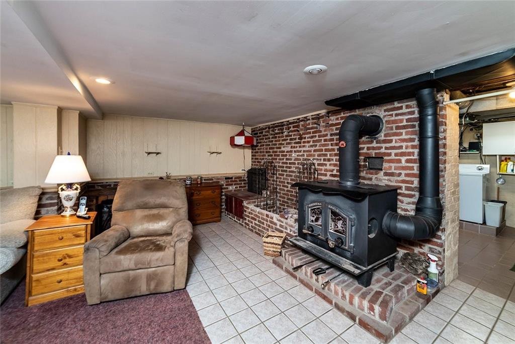 180 Holly Place Road Mount Pleasant, PA 15666 - Photo 18 of 23 GAMEROOM WITH FREE STANDING WOOD BURNER. WOOD BURNER IS AUXILIARY HEAT FOR THE ENTIRE HOME.