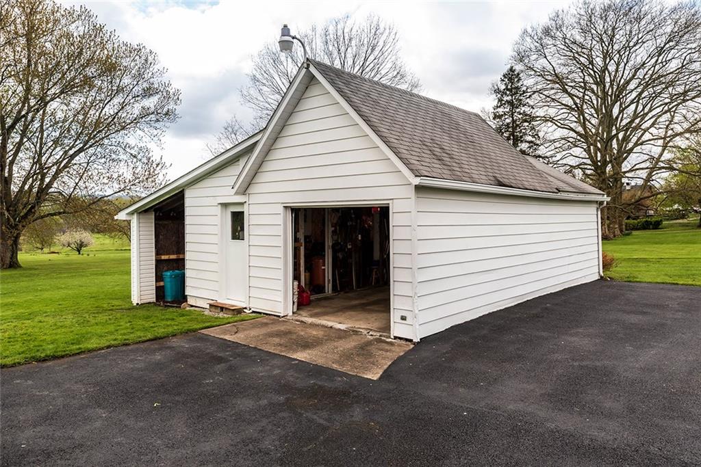 180 Holly Place Road Mount Pleasant, PA 15666 - Photo 21 of 23 DETACHED 1 CAR GARAGE, AUTO DOOR OPOENER, ATTACHED WOOD/WORKSHOP AND COVERED STORAGE AREA.