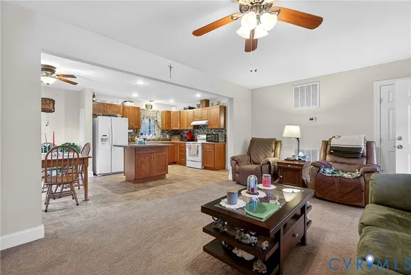 a living room with furniture and kitchen view