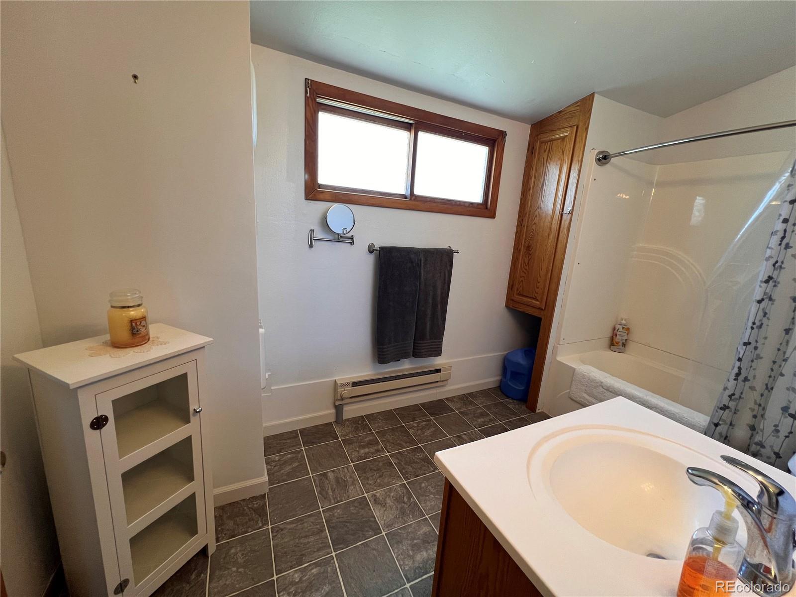 204 Main Street Genoa, CO 80818 - Photo 11 of 25 a bathroom with a sink and a mirror