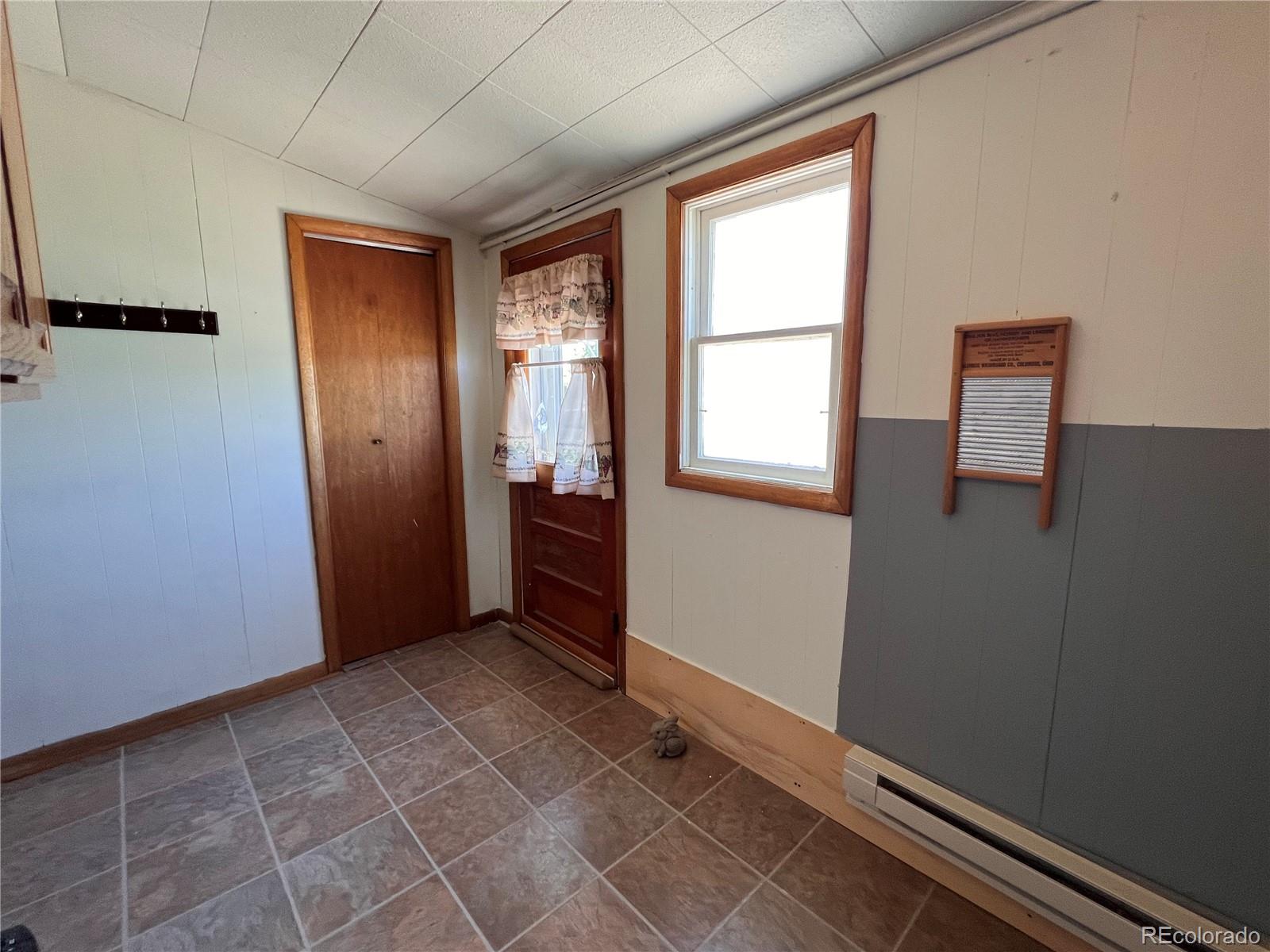 204 Main Street Genoa, CO 80818 - Photo 12 of 25 an empty room with windows and closet
