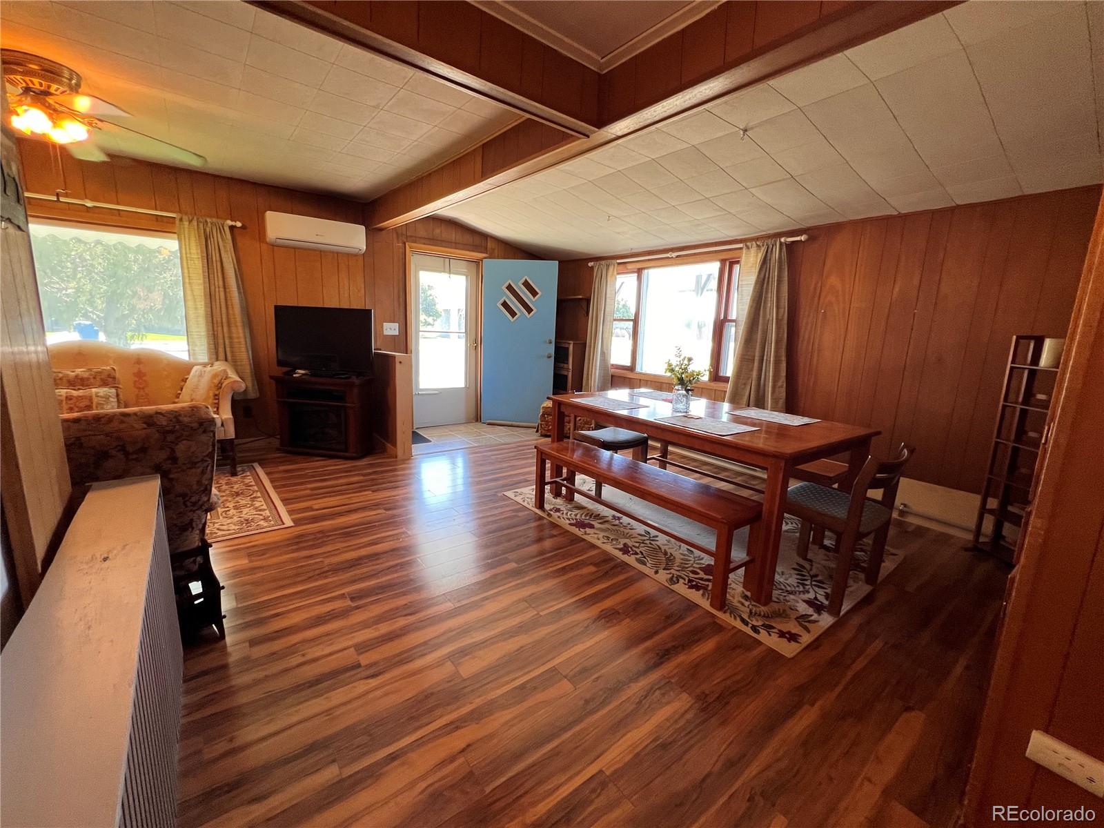 204 Main Street Genoa, CO 80818 - Photo 17 of 25 a living room with furniture a wooden floor and a piano