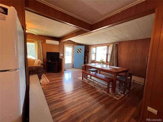 a living room with furniture a table and wooden floor