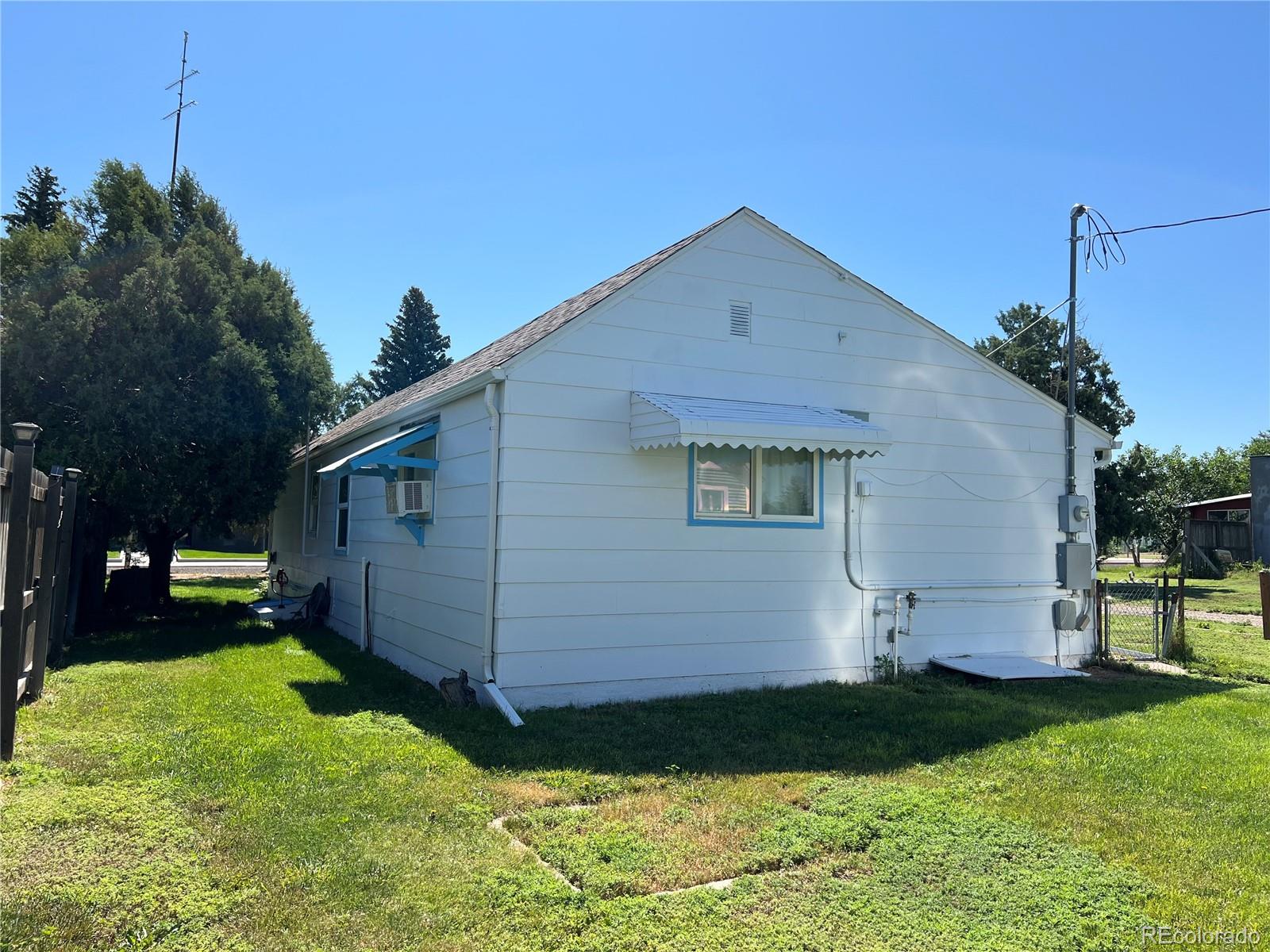 204 Main Street Genoa, CO 80818 - Photo 21 of 25 a front view of a house with a yard