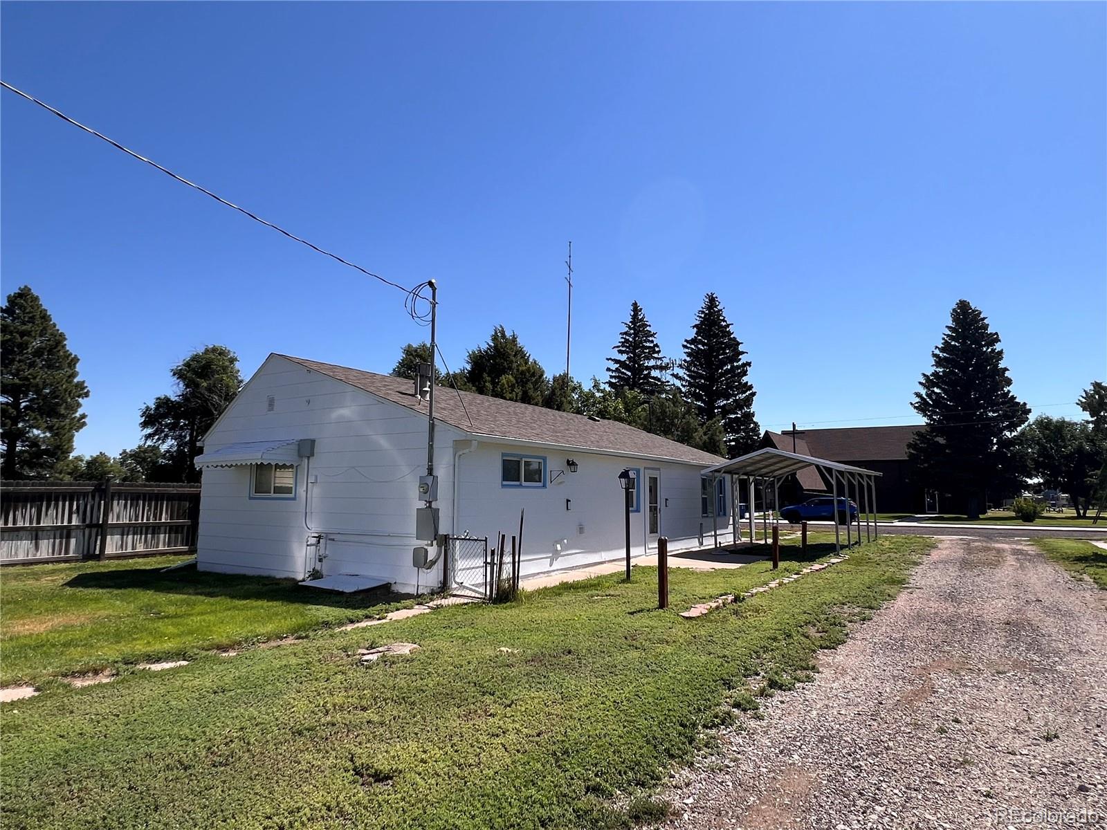 204 Main Street Genoa, CO 80818 - Photo 22 of 25 a front view of house with a garden