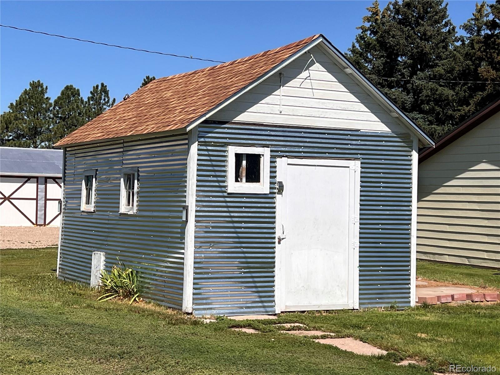 204 Main Street Genoa, CO 80818 - Photo 23 of 25 a view of a house with a yard