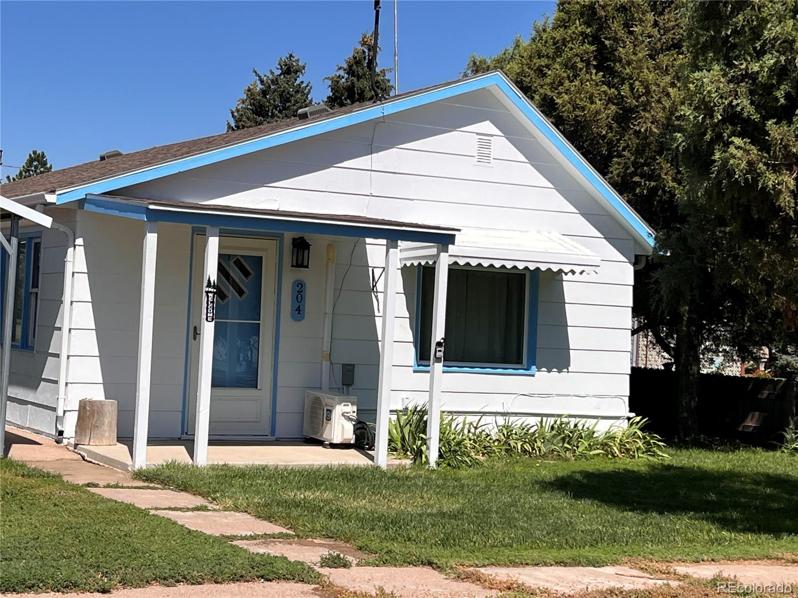204 Main Street Genoa, CO 80818 - Photo 3 of 25 a front view of a house with a yard