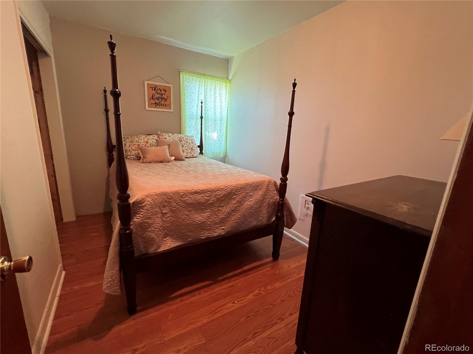 204 Main Street Genoa, CO 80818 - Photo 5 of 25 a bedroom with a bed and a mirror