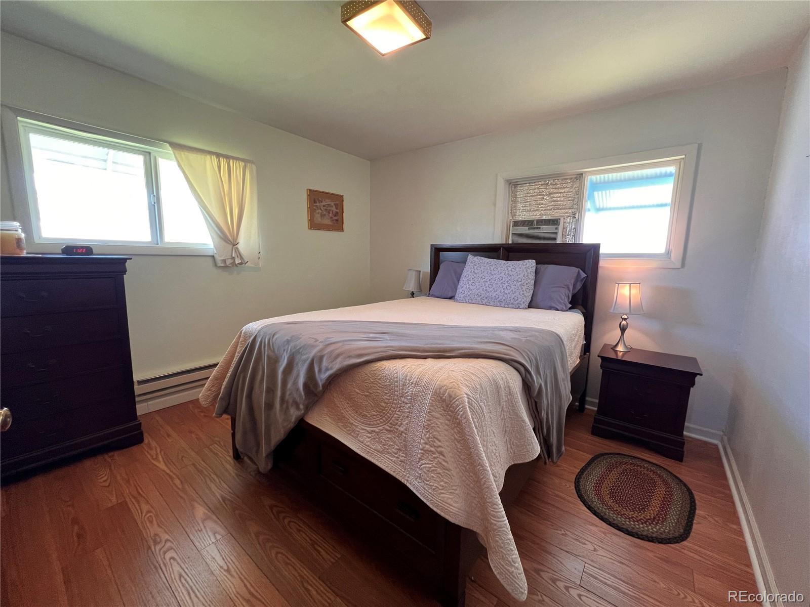 204 Main Street Genoa, CO 80818 - Photo 6 of 25 a bedroom with a bed and wooden floor