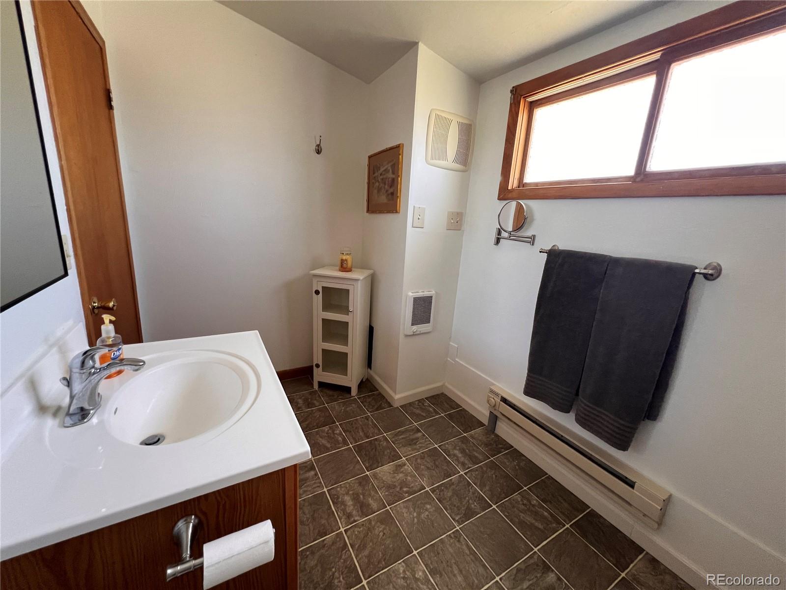 204 Main Street Genoa, CO 80818 - Photo 7 of 25 a bathroom with a sink and a mirror