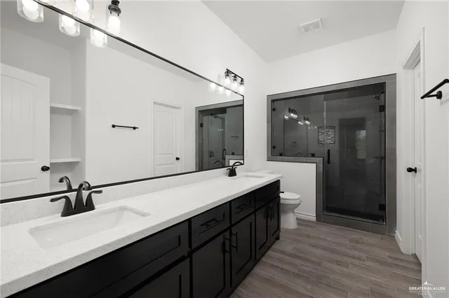 a bathroom with a double vanity sink and a mirror