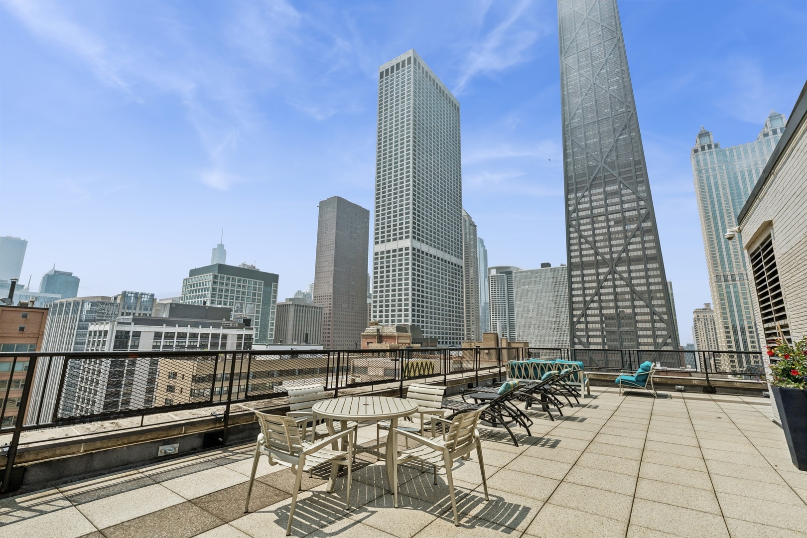 253 East Delaware Place, Unit 4D Chicago, IL 60611 - Photo 13 of 14 a view of balcony with two chairs and a rug