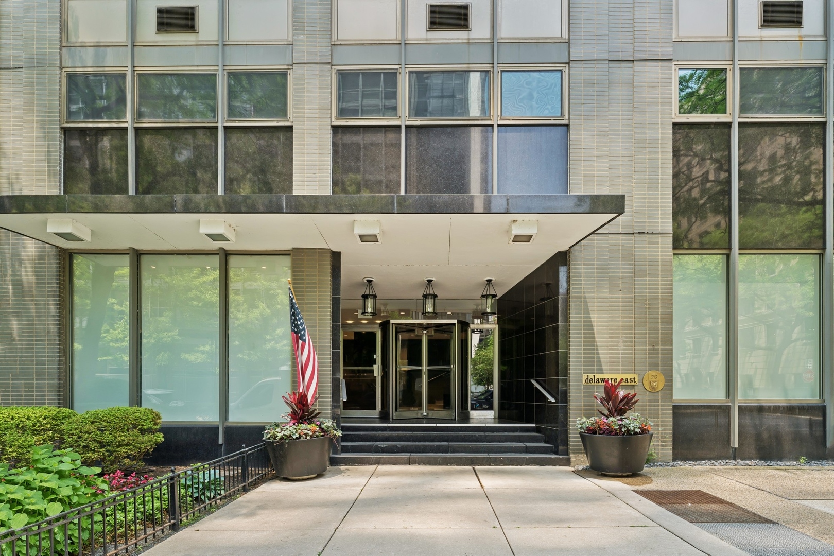 253 East Delaware Place, Unit 4D Chicago, IL 60611 - Photo 2 of 14 a front view of a building with a entryway