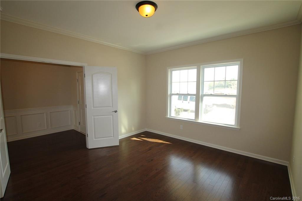 2032 Fuschia Court, Unit 136 Fort Mill, SC 29708 - Photo 2 of 22 an empty room with wooden floor and windows