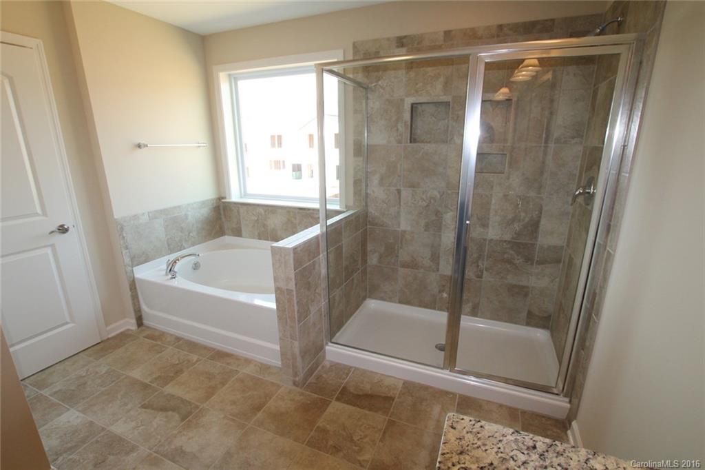 2032 Fuschia Court, Unit 136 Fort Mill, SC 29708 - Photo 11 of 22 a bathroom with a bathtub and a shower