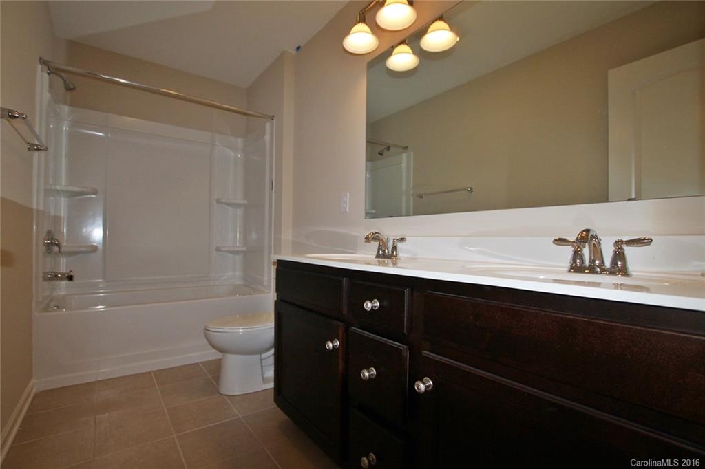 2032 Fuschia Court, Unit 136 Fort Mill, SC 29708 - Photo 13 of 22 a bathroom with a double vanity sink and a bathtub