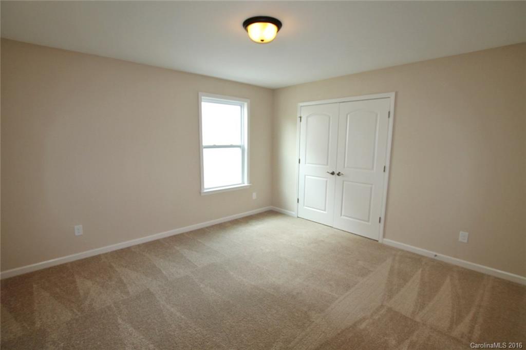 2032 Fuschia Court, Unit 136 Fort Mill, SC 29708 - Photo 14 of 22 an empty room with windows and closet area