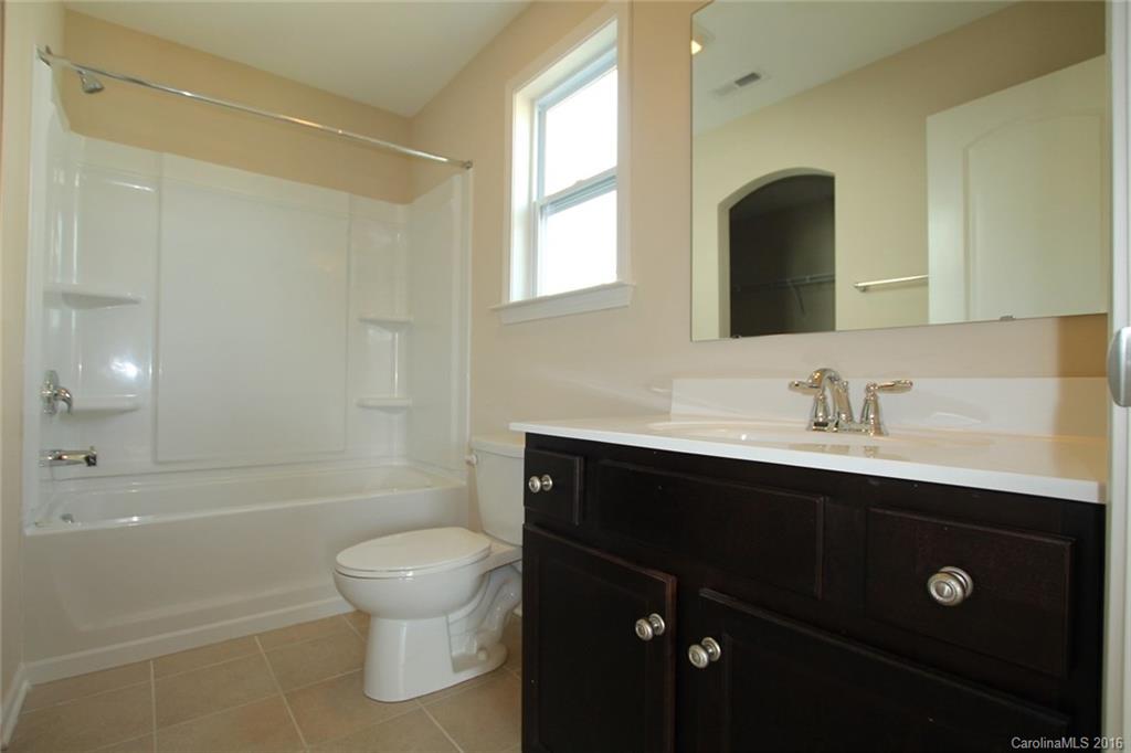 2032 Fuschia Court, Unit 136 Fort Mill, SC 29708 - Photo 15 of 22 a bathroom with a sink a toilet and shower