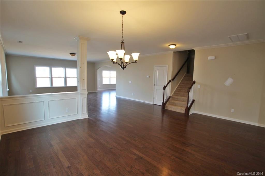 2032 Fuschia Court, Unit 136 Fort Mill, SC 29708 - Photo 4 of 22 a view of a room with wooden floor and chandelier