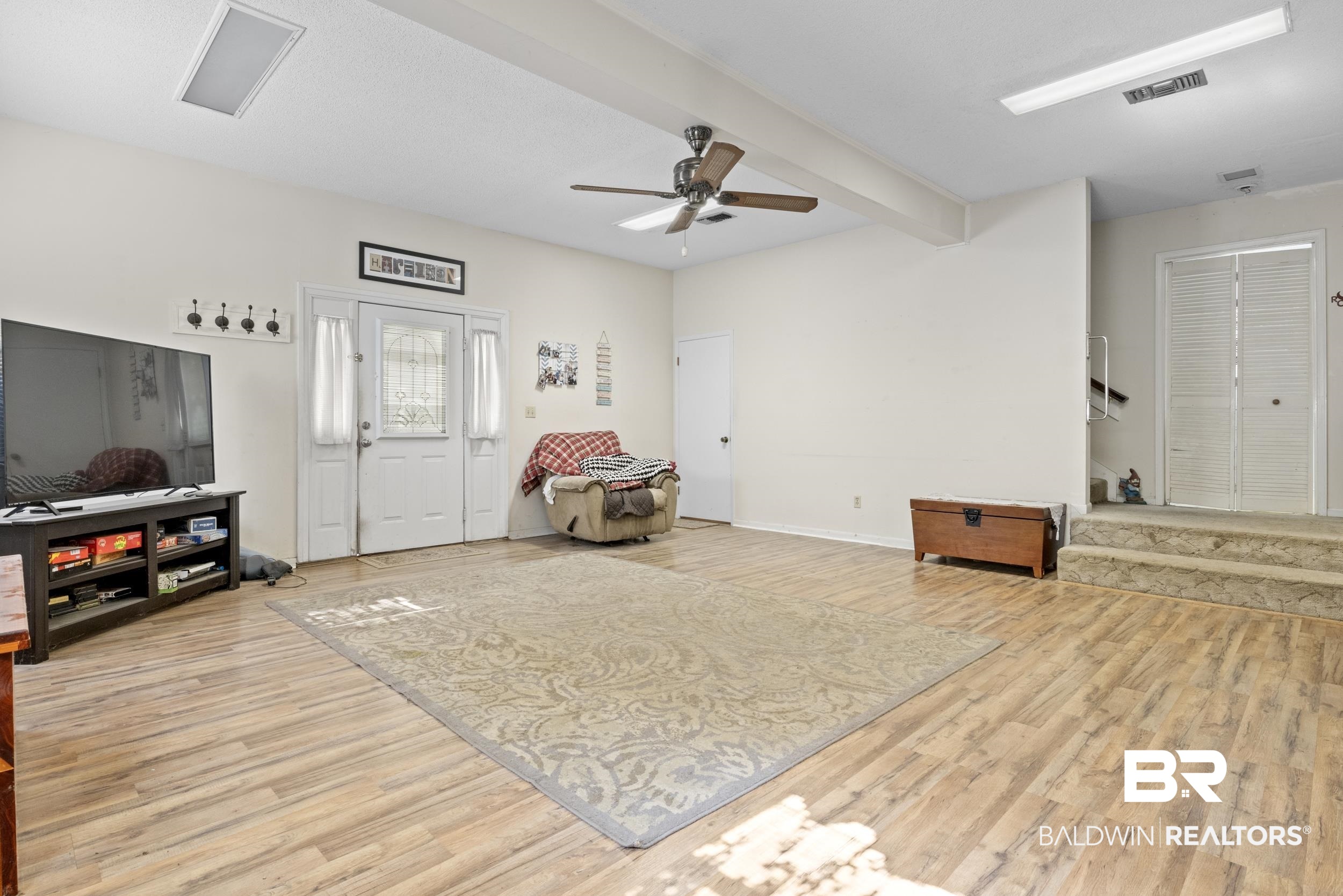 8701 A Rosemary Road Eight Mile, AL 36613 - Photo 6 of 27 Living area featuring ceiling fan, light wood-type flooring, and beamed ceiling