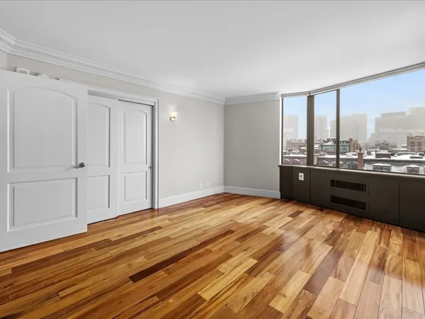 a view of a room with wooden floor