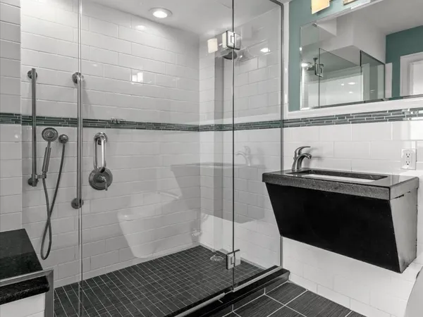 a bathroom with a sink and shower