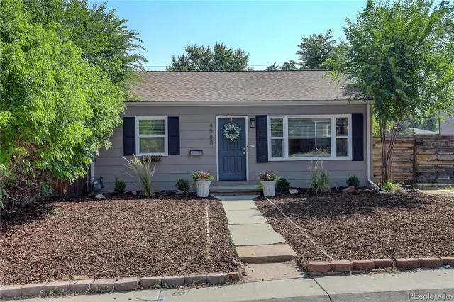 a front view of a house with lots of trees