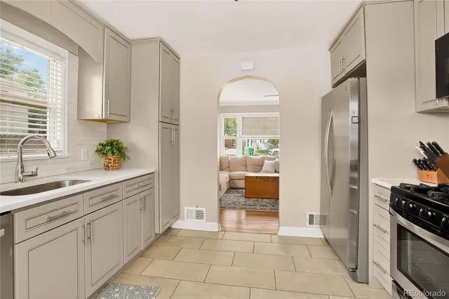 a kitchen with stainless steel appliances granite countertop a refrigerator and a sink