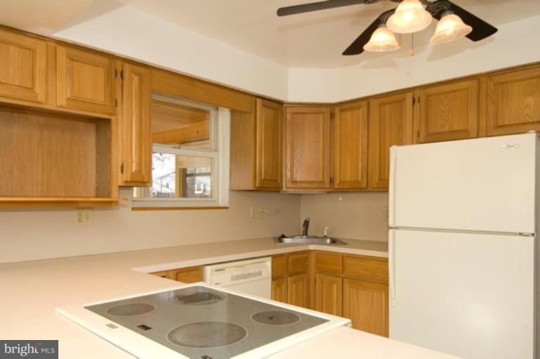 6804 Front Royal Road Springfield, VA 22151 - Photo 11 of 27 a kitchen with a sink a refrigerator and cabinets
