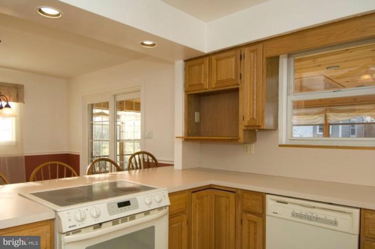 6804 Front Royal Road Springfield, VA 22151 - Photo 12 of 27 a kitchen with granite countertop a stove a sink and a microwave