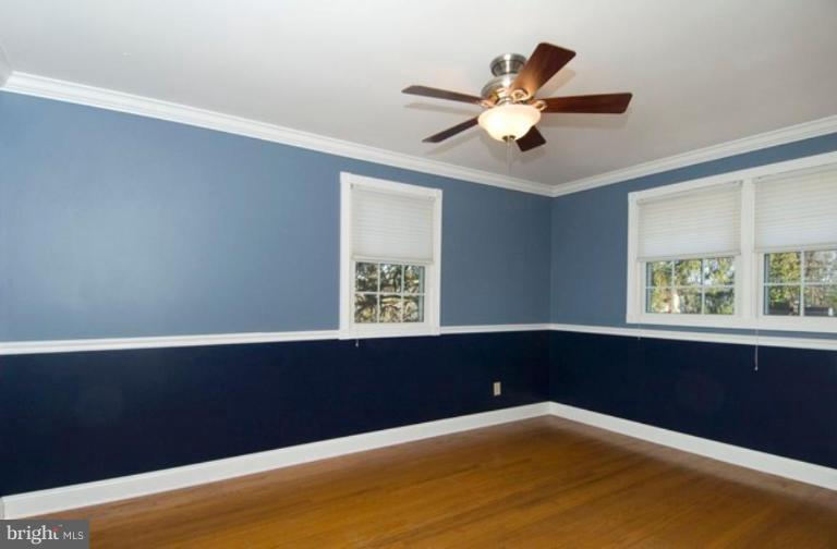 6804 Front Royal Road Springfield, VA 22151 - Photo 16 of 27 a view of an empty room with wooden floor and a window