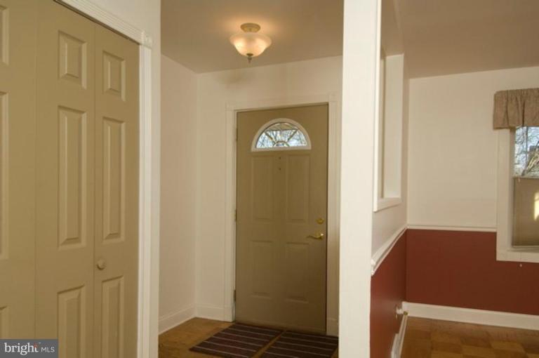 6804 Front Royal Road Springfield, VA 22151 - Photo 6 of 27 a view of a hallway with wooden floor and a livingroom
