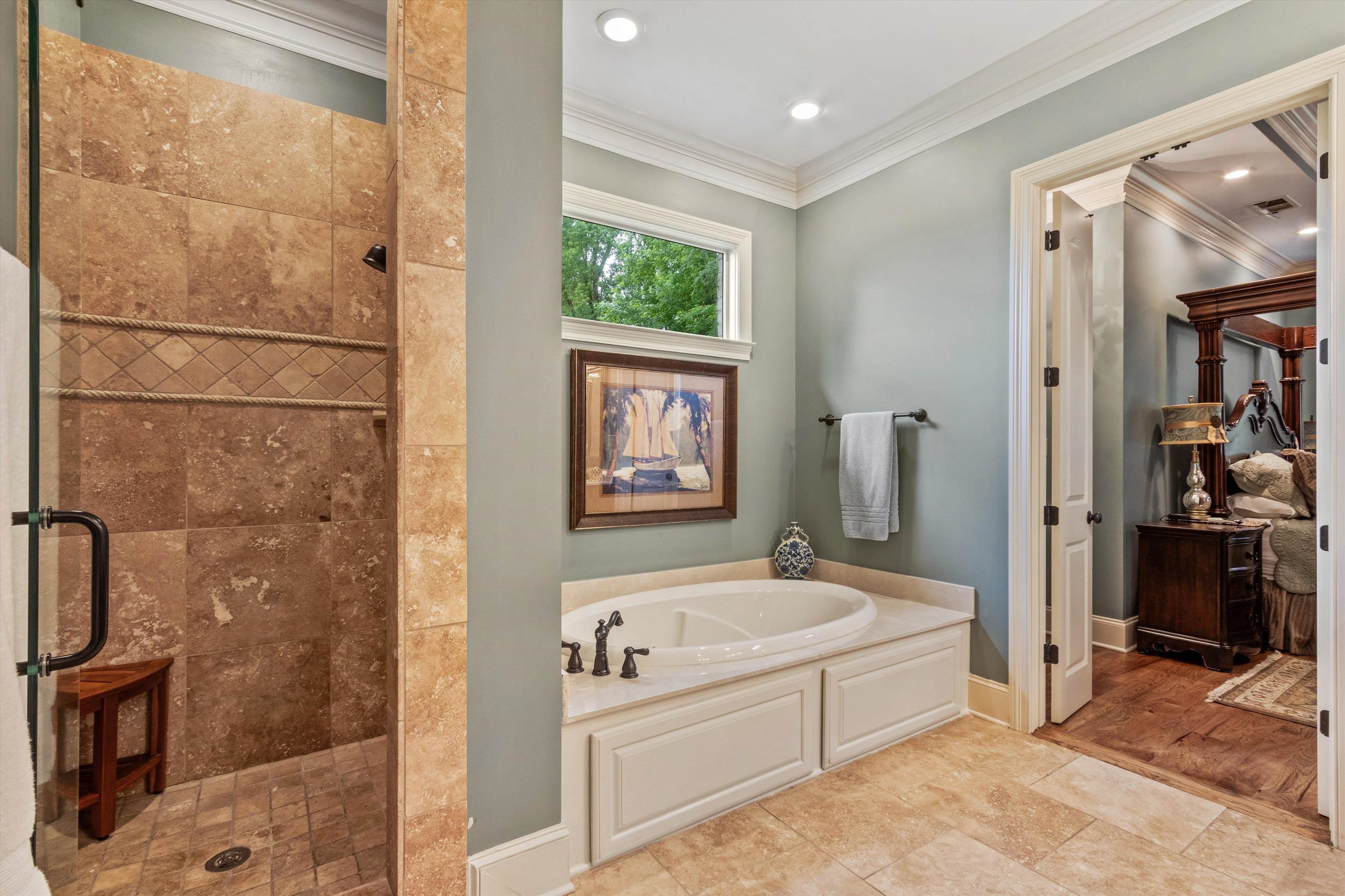 150 Ridgecrest Drive Arlington, TN 38002 - Photo 22 of 40 Spacious bathroom featuring a built-in soaking tub with paneled surround, a large walk-in shower with tile walls and glass enclosure, and recessed lighting