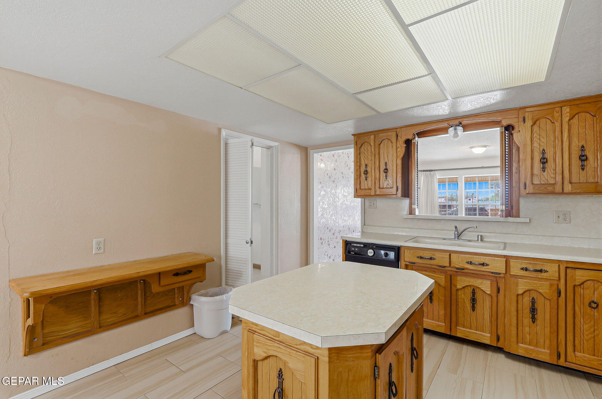 520 Cardon Street El Paso, TX 79903 - Photo 19 of 42 a kitchen with a stove and white cabinets