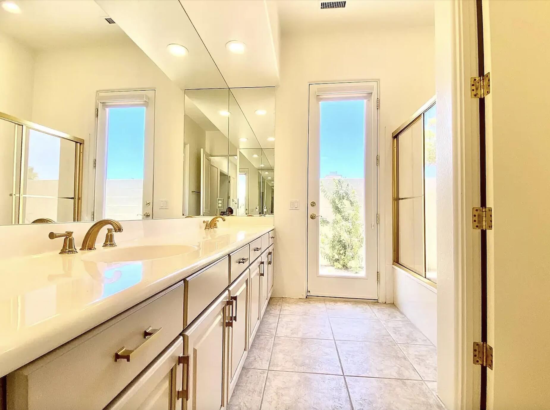 5 Victoria Falls Drive Rancho Mirage, CA 92270 - Photo 25 of 26 a spacious bathroom with a double vanity sink and a large mirror