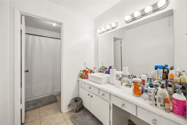 a bathroom with a double vanity sink mirror and shower