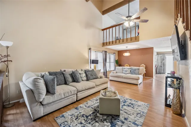 a living room with furniture a rug and a chandelier