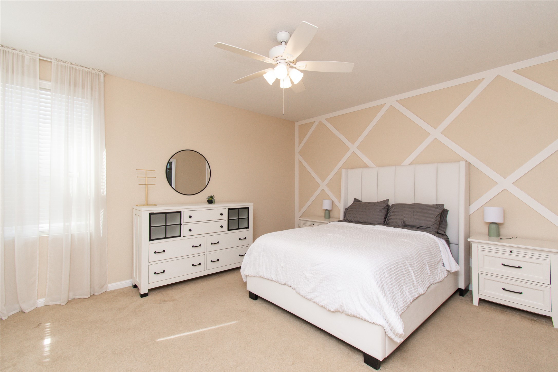 421 Shadow Point San Marcos, TX 78666 - Photo 10 of 24 Bedroom featuring light carpet, a ceiling fan, and an accent wall