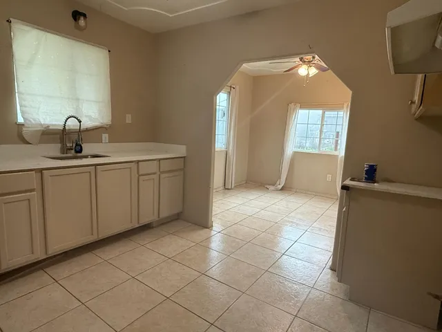 a spacious bathroom with a double vanity sink a mirror and a bathtub