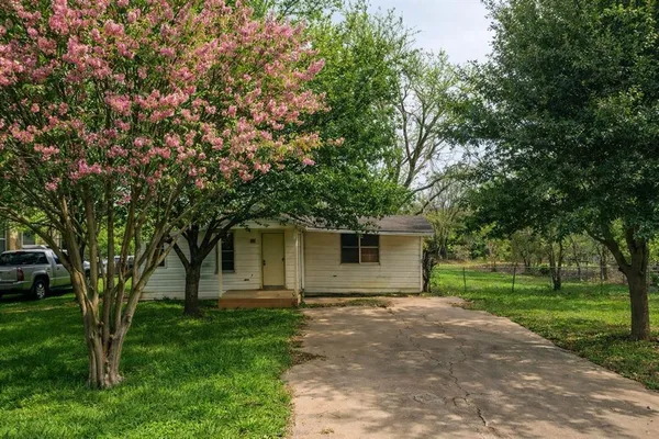 a front view of house with yard and green space