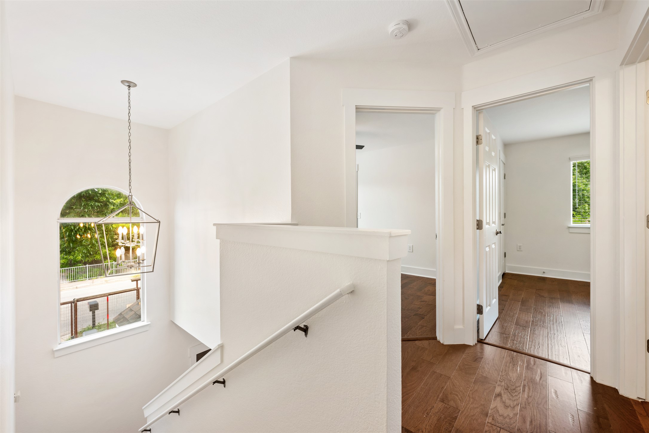 4912 Sara Drive, Unit A Austin, TX 78721 - Photo 16 of 28 Staircase and upstairs landing featuring hardwood throughout the home