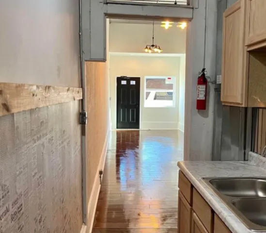 a kitchen with refrigerator and window