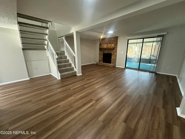 wooden floor in an empty room with a window