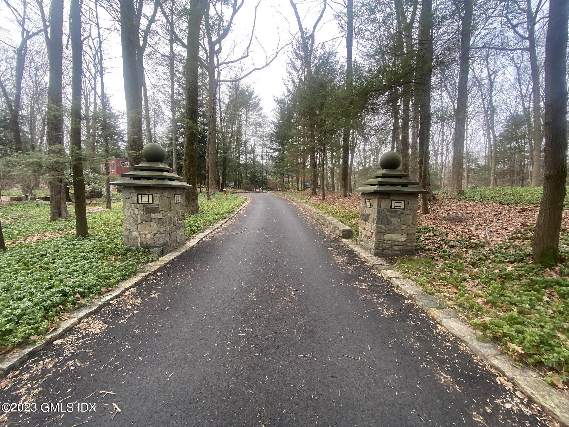 a view of a street with large trees