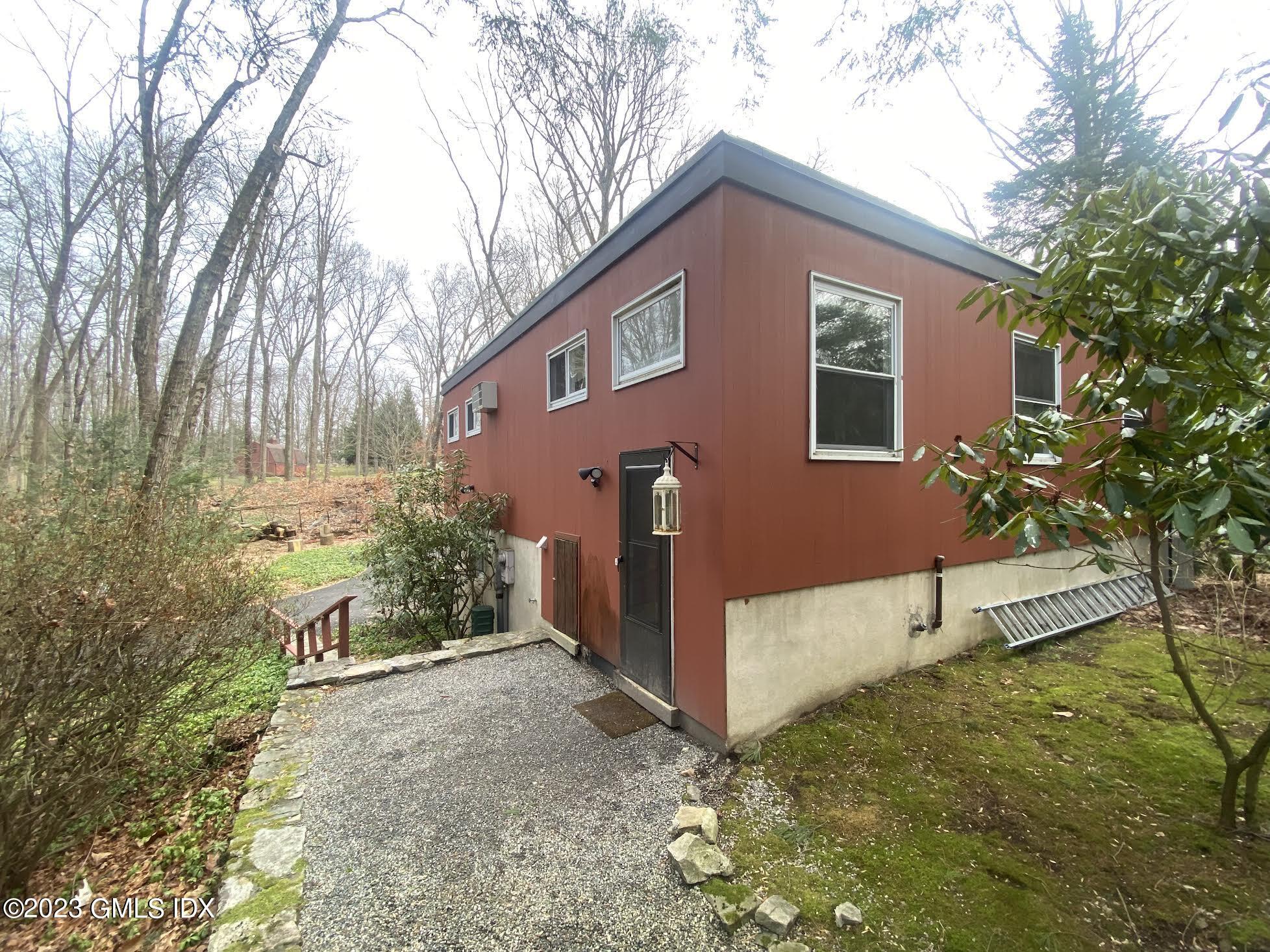 21 Hycliff Road Greenwich, CT 06831 - Photo 3 of 13 a front view of a house with a yard