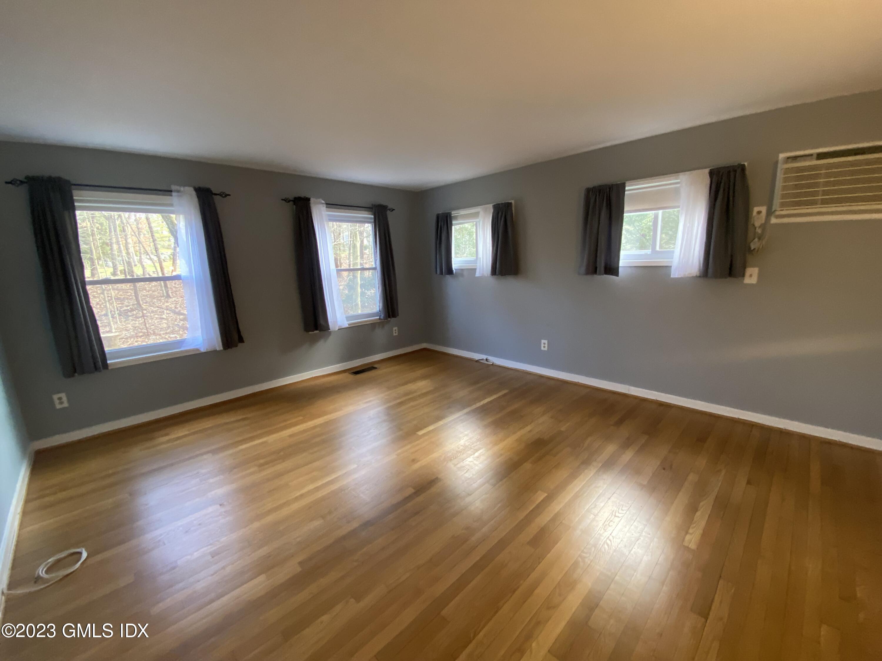 21 Hycliff Road Greenwich, CT 06831 - Photo 6 of 13 a view of empty room with wooden floor and fan